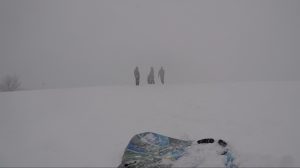 An image of Kevin, Tricia, and Logan standing on top of a snowy hill.