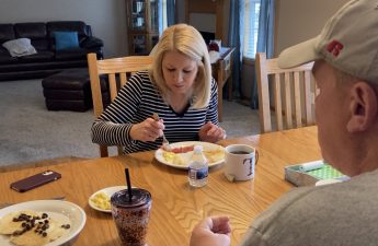 An image of Kevin and Tricia Holle eating breakfast at the kitchen table.