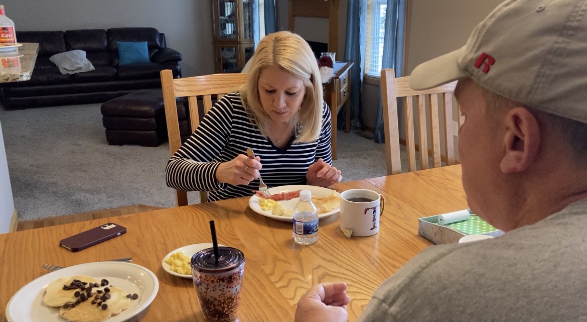 An image of Kevin and Tricia Holle eating breakfast at the kitchen table.