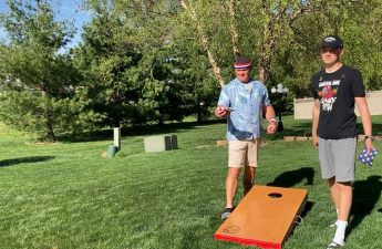 An image of Logan Holle and Kevin Holle playing cornhole.