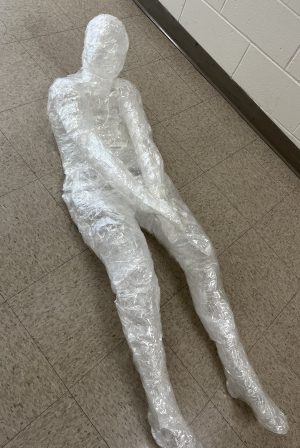 An image of a three-dimensional body made from Saran Wrap and packing tape.