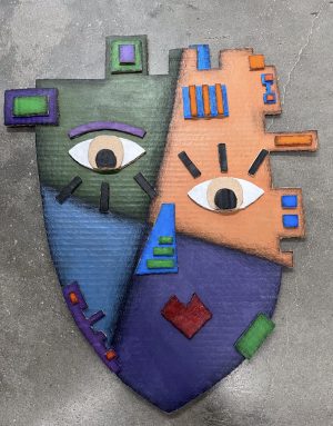 An image of a colorful, face sculpture.